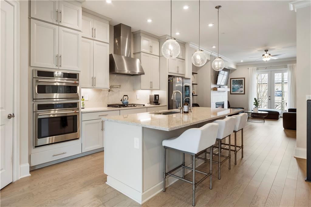 884 Mayfield Road Milton, GA 30004 - Photo 5 of 20 a large kitchen with stainless steel appliances a stove center island a cabinets and wooden floor