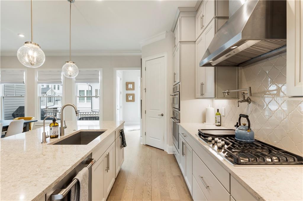 884 Mayfield Road Milton, GA 30004 - Photo 6 of 20 a kitchen with stainless steel appliances granite countertop a sink a stove oven a counter space and cabinets
