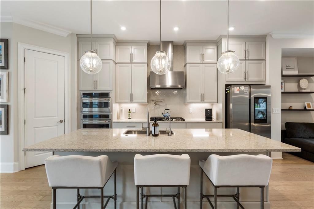 884 Mayfield Road Milton, GA 30004 - Photo 7 of 20 a kitchen with granite countertop a table chairs stove and cabinets