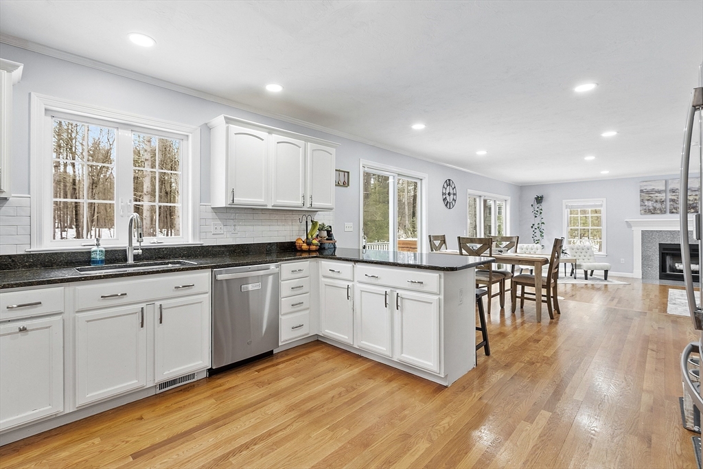 2 Gabes Place Lunenburg, MA 01462 - Photo 12 of 41 a kitchen with stainless steel appliances granite countertop wooden floors and white cabinets