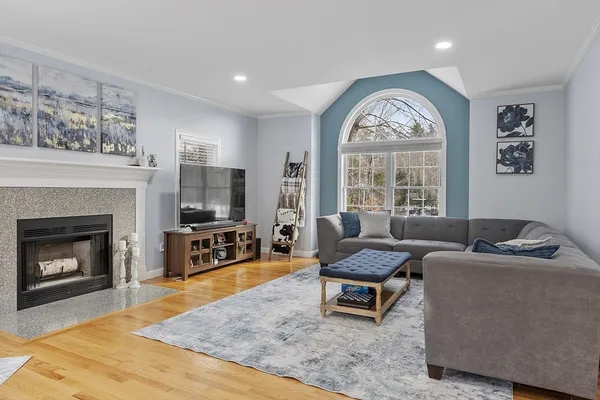 a living room with furniture a fireplace and a flat screen tv