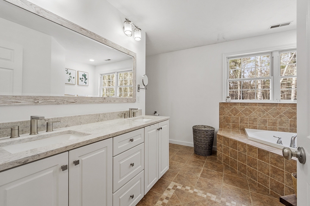 2 Gabes Place Lunenburg, MA 01462 - Photo 28 of 41 a spacious bathroom with a granite countertop sink a mirror and a bathtub