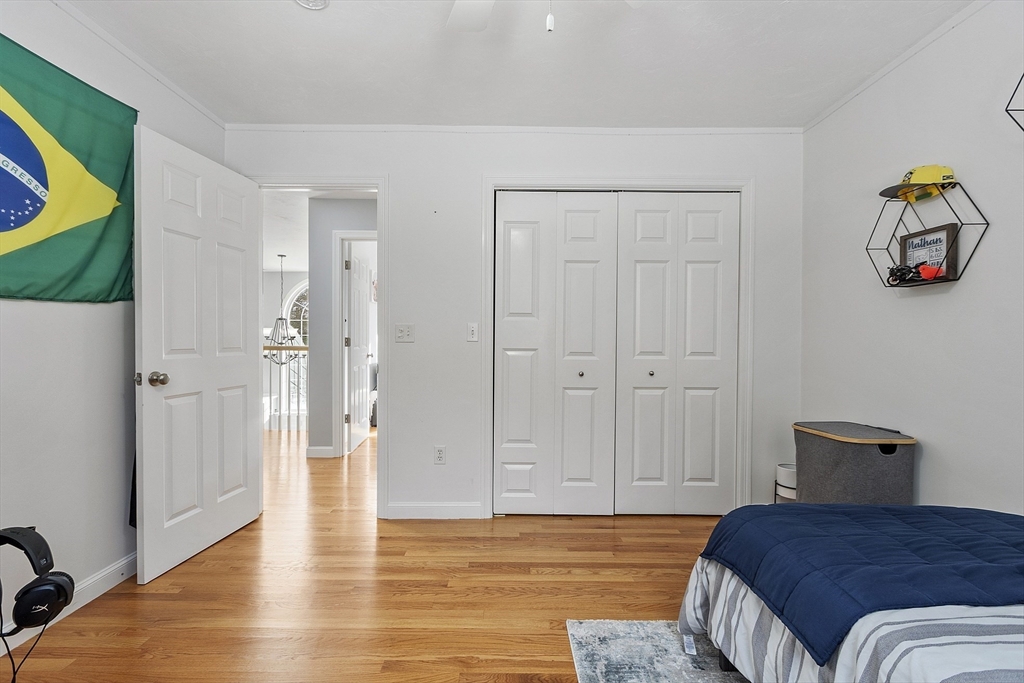 2 Gabes Place Lunenburg, MA 01462 - Photo 34 of 41 a bedroom with a bed and a chandelier