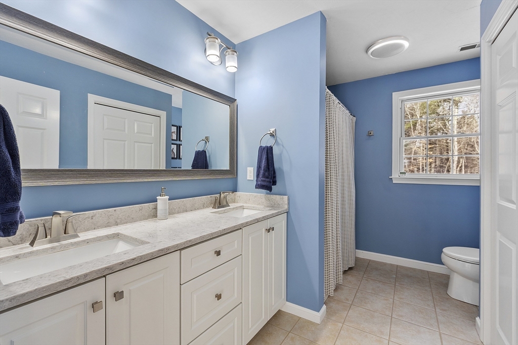 2 Gabes Place Lunenburg, MA 01462 - Photo 35 of 41 a bathroom with a granite countertop sink a toilet and a mirror
