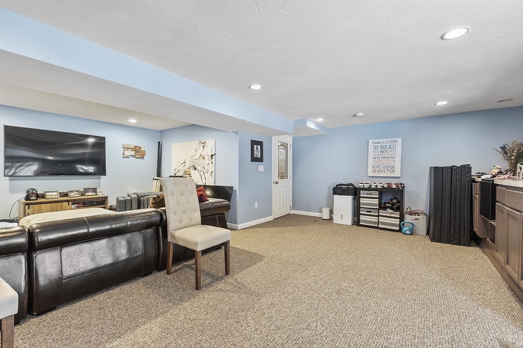 2 Gabes Place Lunenburg, MA 01462 - Photo 41 of 41 a living room with furniture and a flat screen tv
