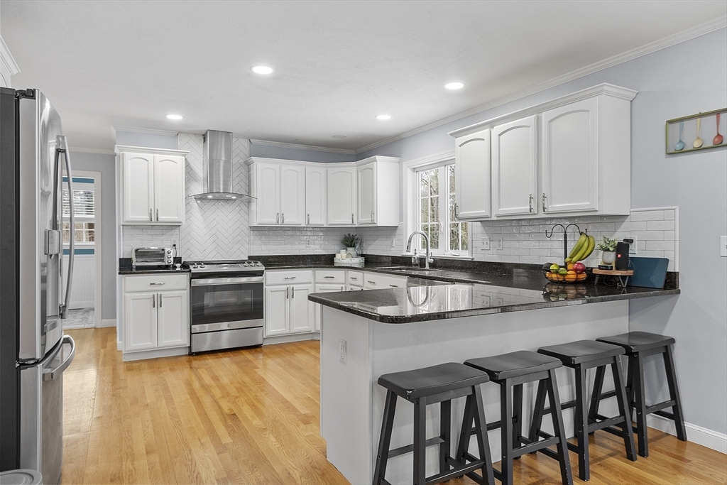 2 Gabes Place Lunenburg, MA 01462 - Photo 9 of 41 a kitchen with stainless steel appliances granite countertop a table chairs sink refrigerator and cabinets