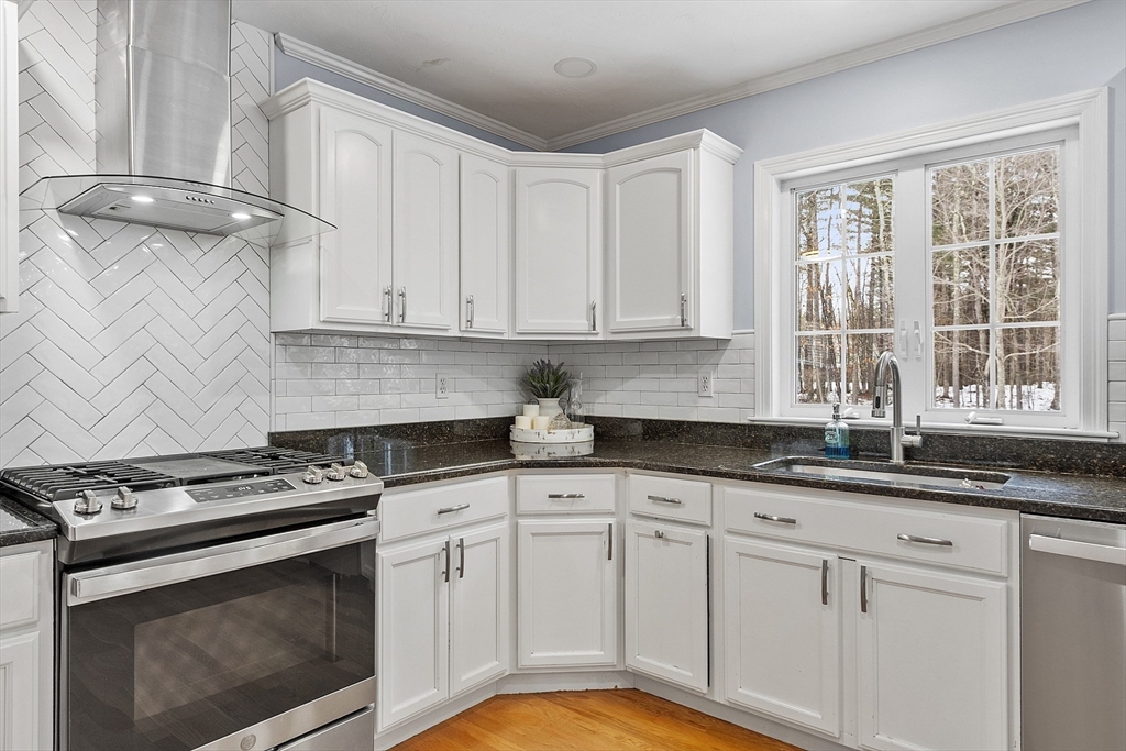 2 Gabes Place Lunenburg, MA 01462 - Photo 10 of 41 a kitchen with granite countertop stainless steel appliances white cabinets granite counter tops and a wooden floors