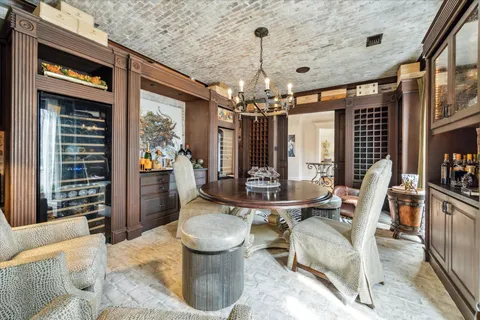 a dining room with furniture a chandelier and window