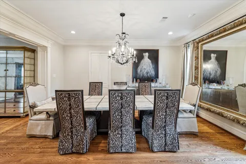 a view of a dining room with furniture wooden floor and chandelier