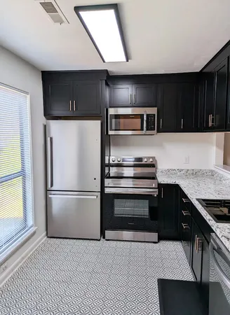 a kitchen with a refrigerator and a sink