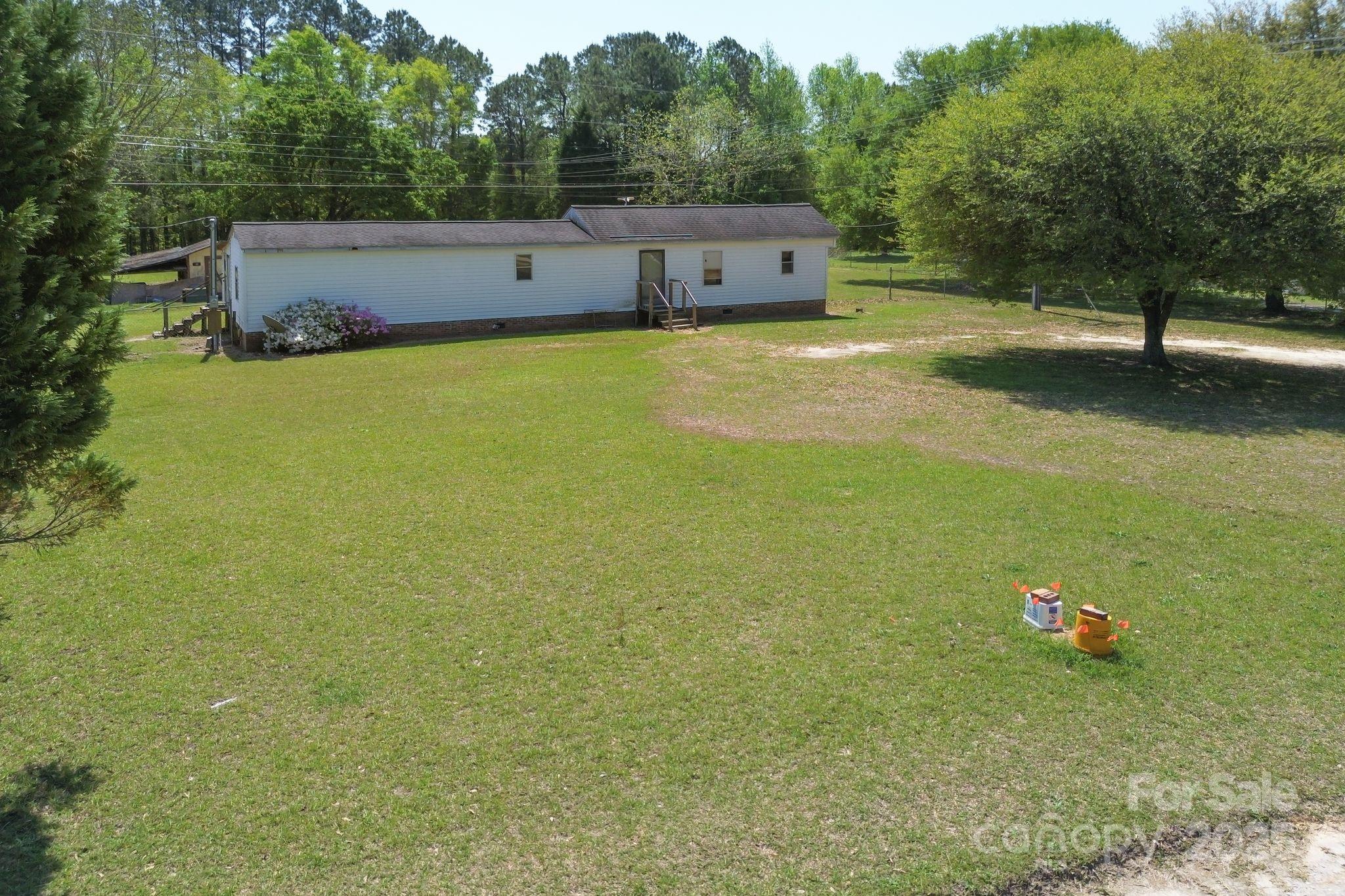 164 Phelps Road Chesterfield, SC 29709 - Photo 18 of 27 a view of a lake with a yard and large trees