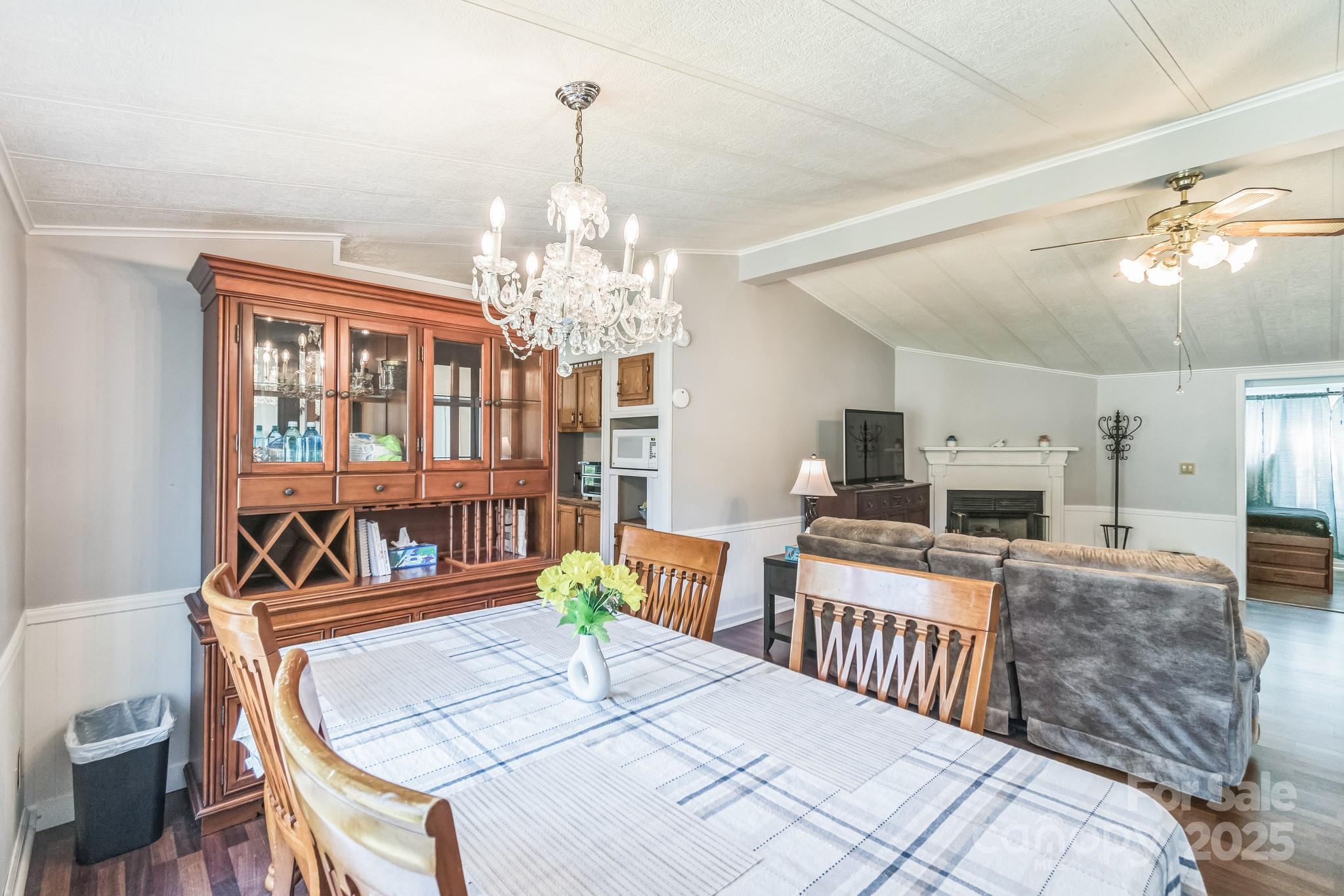 164 Phelps Road Chesterfield, SC 29709 - Photo 3 of 27 a living room with furniture a fireplace and a chandelier