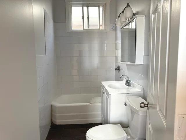 a white toilet sitting next to a bathroom sink