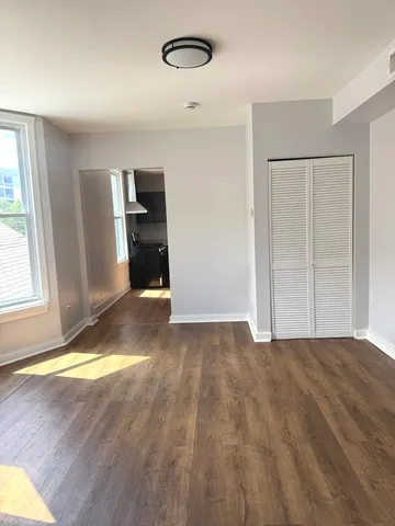 a view of empty room with window and fireplace