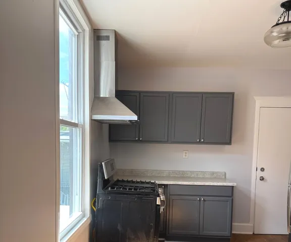 a kitchen with a sink a stove and cabinets