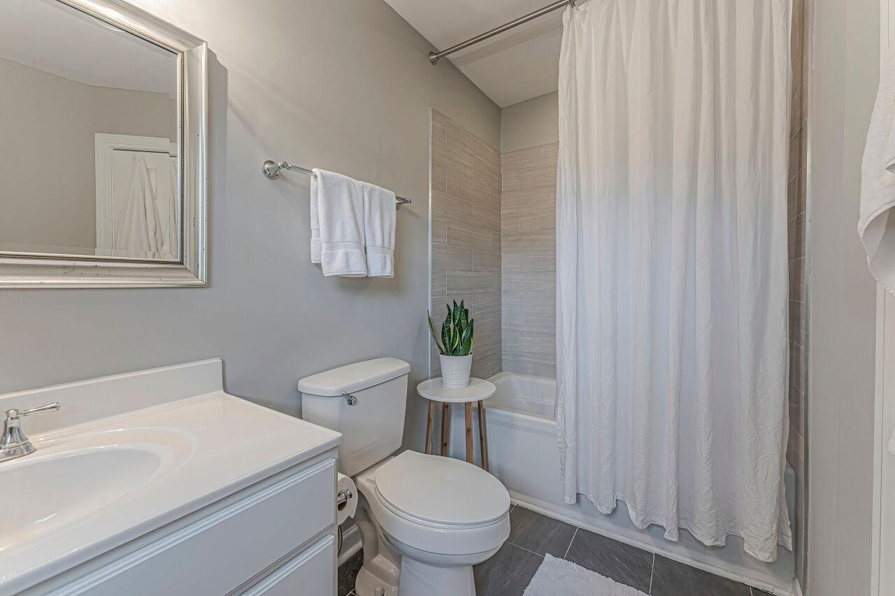 106 Hatfield Lane Raleigh, NC 27603 - Photo 22 of 29 a white toilet sitting next to a bathroom sink