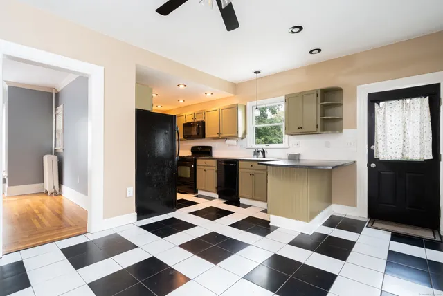 a kitchen with stainless steel appliances kitchen island granite countertop a sink and cabinets