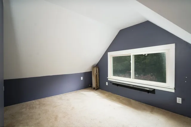 an aerial view of residential houses with outdoor space and parking