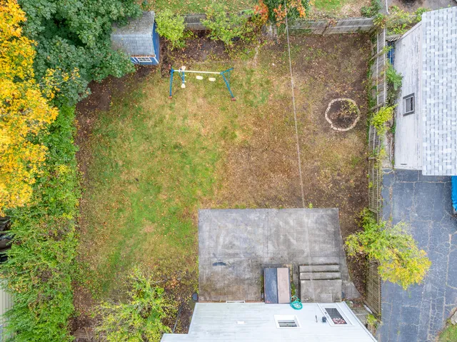 an aerial view of a house with outdoor space