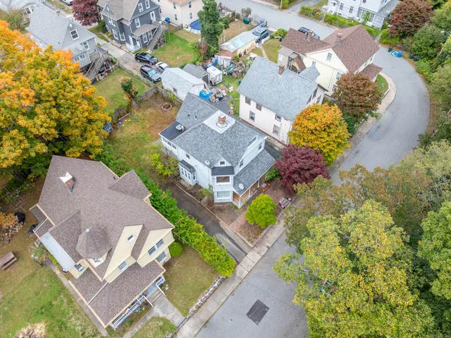 an aerial view of a house with a swimming pool and outdoor space