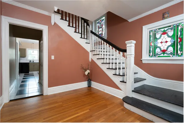a view of entryway and hall with wooden floor