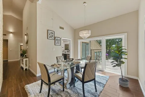 a dining room with furniture window and wooden floor