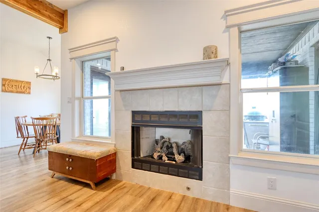 a dining room with kitchen island stainless steel appliances wooden floor and living room view