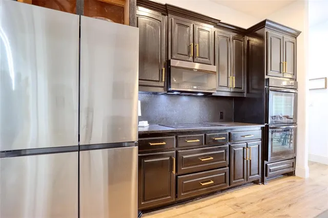a stove top oven sitting inside of a kitchen