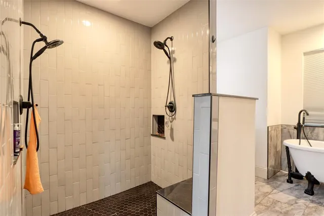 a bathroom with a tub sink and mirror