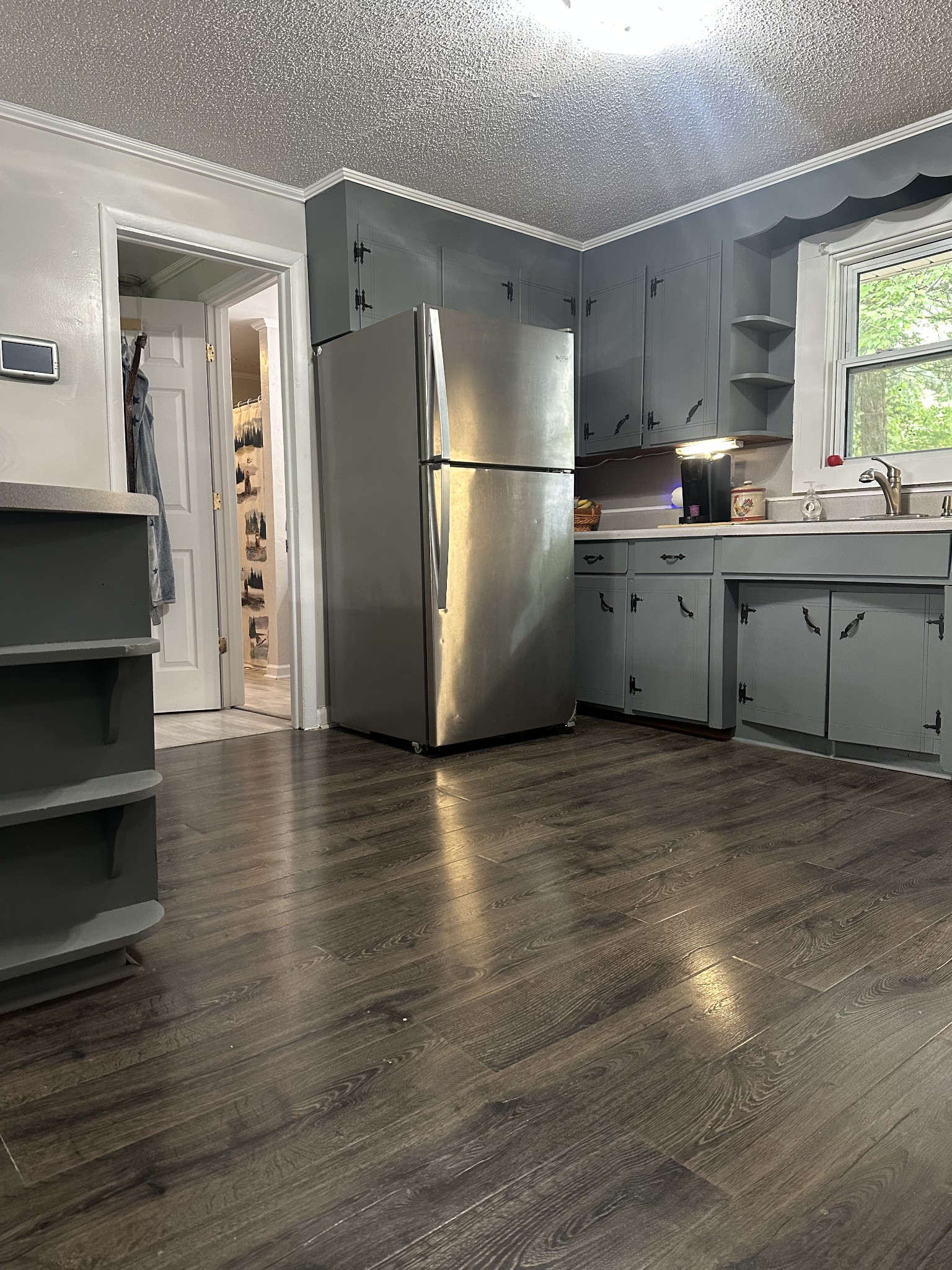 16 Cummings Road Summertown, TN 38483 - Photo 23 of 33 a kitchen with stainless steel appliances a refrigerator a sink cabinets and wooden floor
