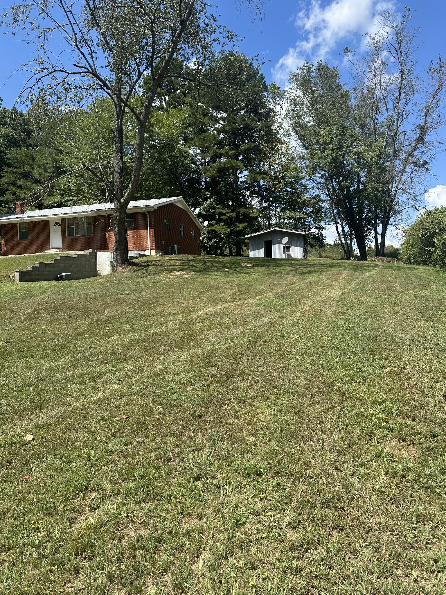16 Cummings Road Summertown, TN 38483 - Photo 6 of 33 a front view of a house with a garden