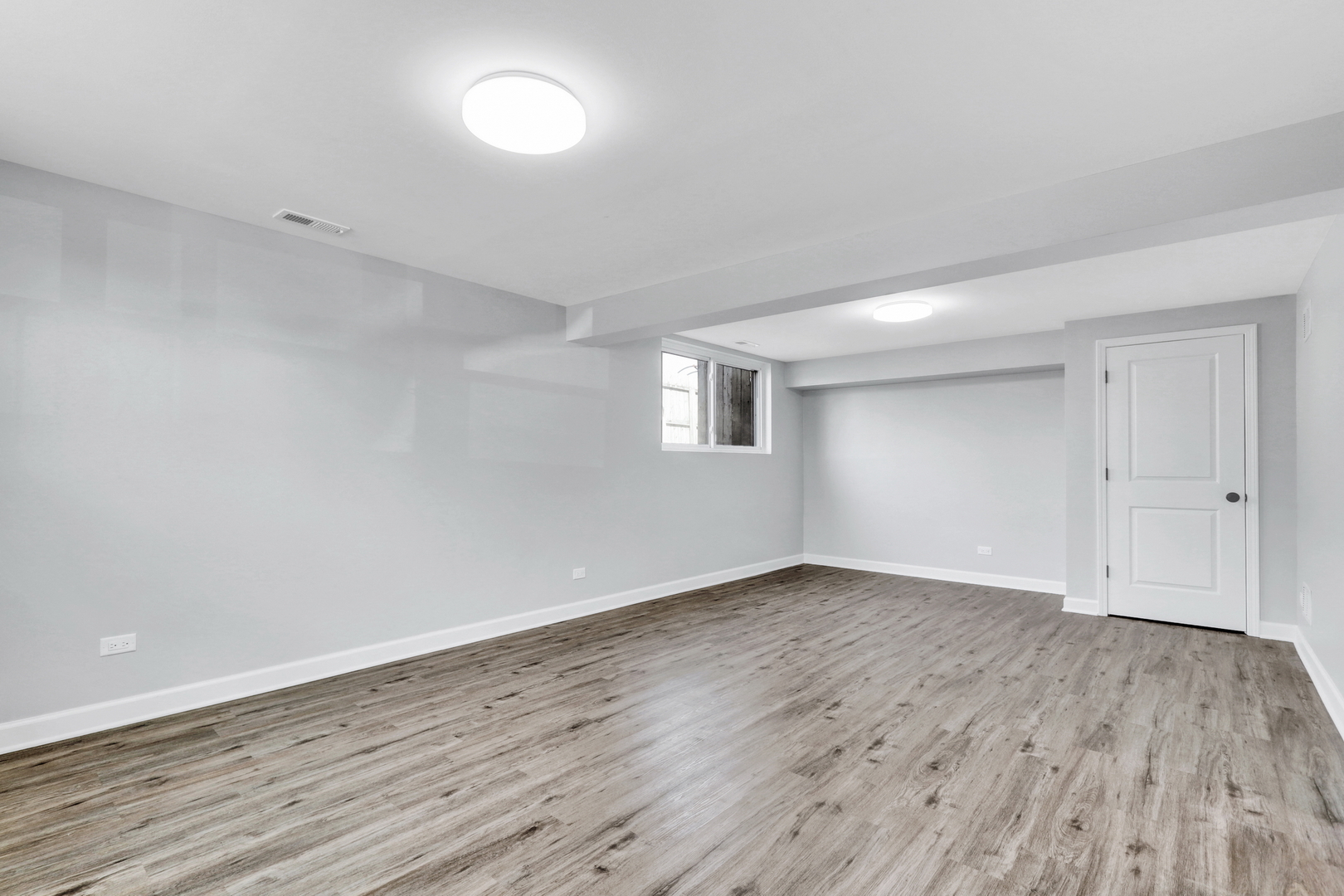 411 Northgate Road Lindenhurst, IL 60046 - Photo 14 of 18 a view of an empty room with wooden floor and a window