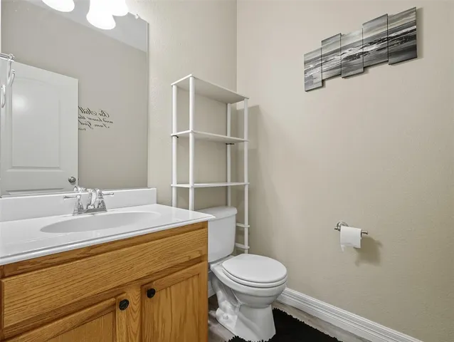 a bathroom with a sink a toilet and vanity