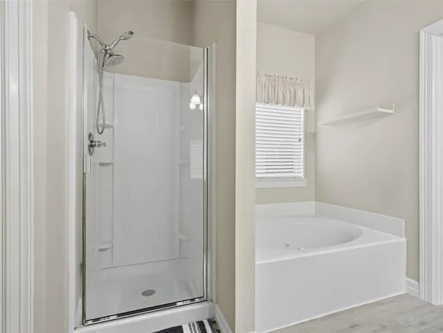 a bathroom with a bathtub and shower