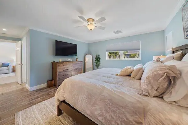 a bedroom with a bed and a flat screen tv