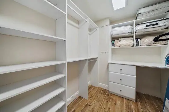 a view of walk in closet with empty racks