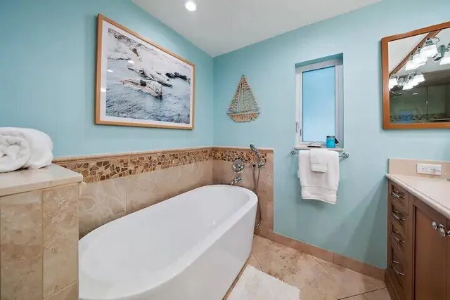 a living room with a couch and a painting on the wall