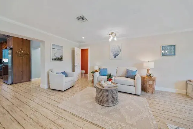 a living room with furniture and a wooden floor