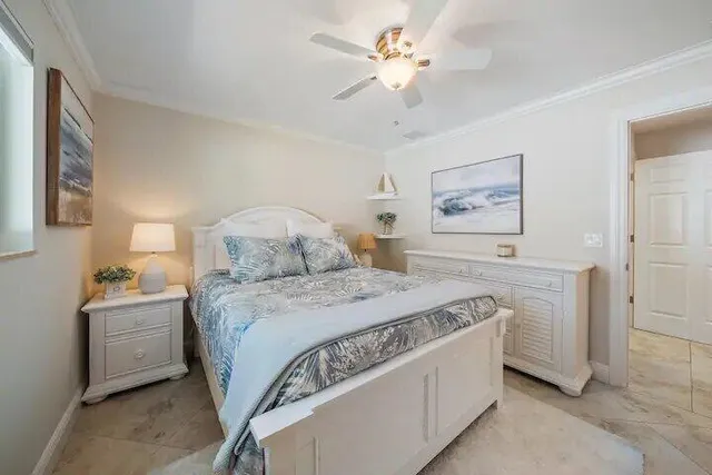 a spacious bedroom with a bed and a chandelier