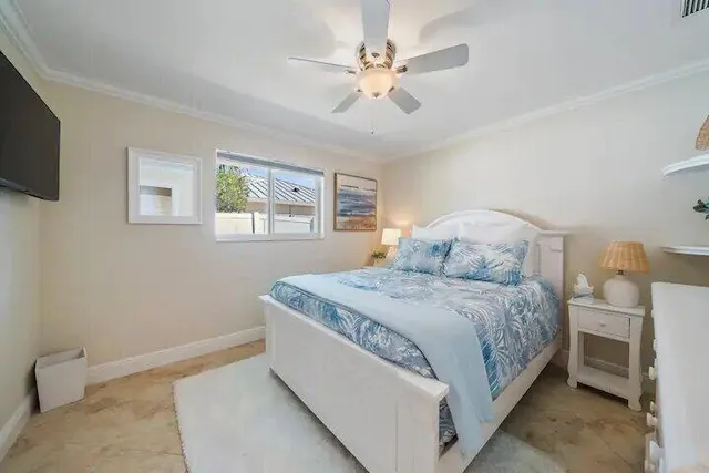 a bedroom with a bed dresser and a window