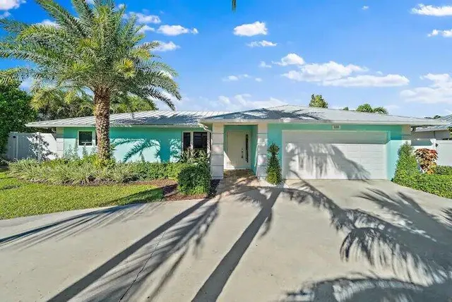 a view of a house with backyard and a patio