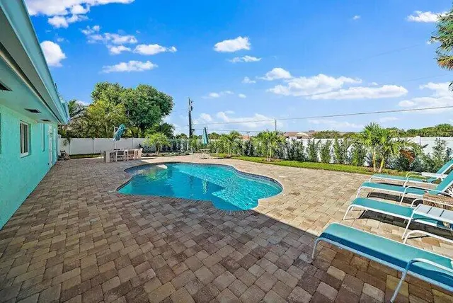 a view of a swimming pool with a yard
