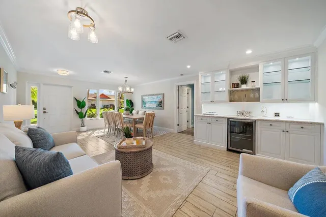 a living room with furniture and a kitchen view