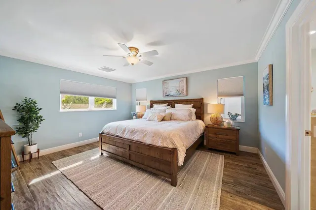 a bedroom with a bed and wooden floor
