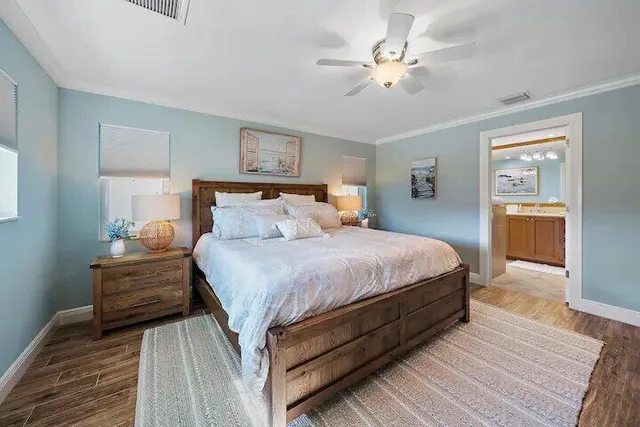 a bedroom with a bed and a chandelier