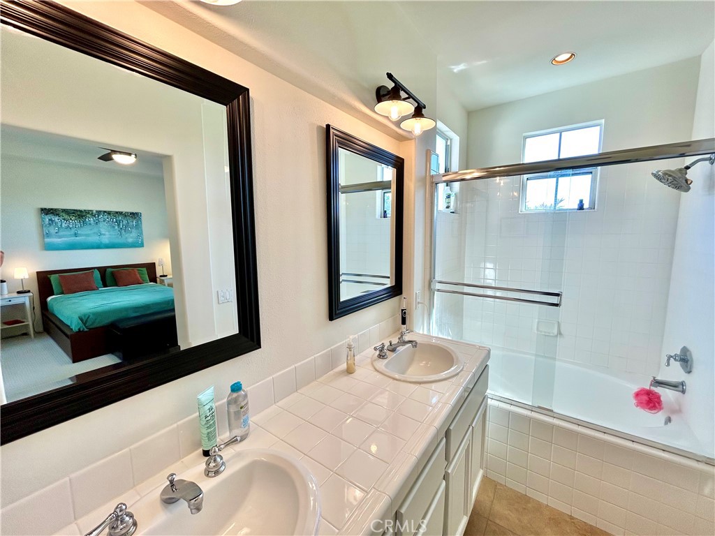 2811 Caponi Place Tustin, CA 92782 - Photo 20 of 50 a bathroom with a tub sink and mirror