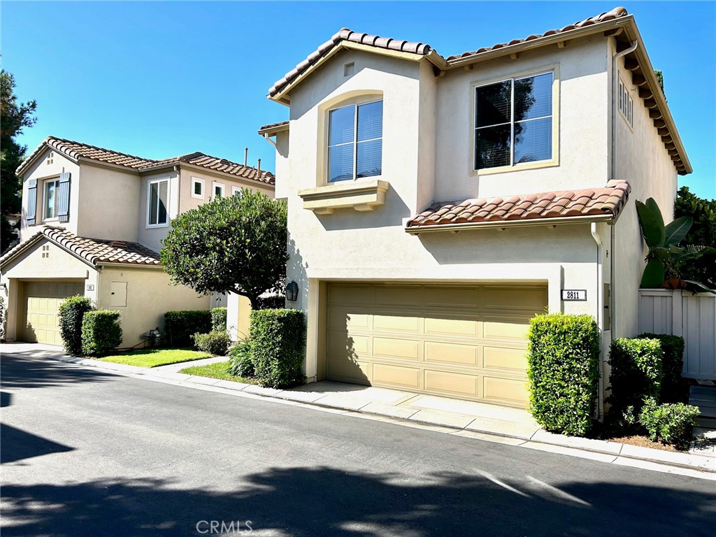 2811 Caponi Place Tustin, CA 92782 - Photo 32 of 50 a front view of a house with a garden and garage