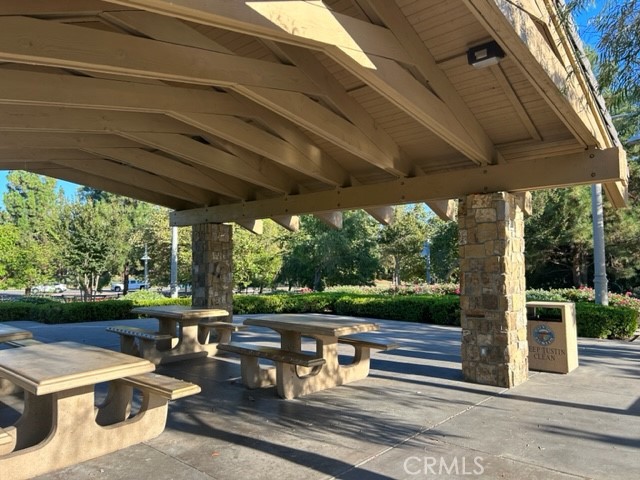 2811 Caponi Place Tustin, CA 92782 - Photo 44 of 50 a view of a patio with table and chairs potted plants with wooden floor and fence