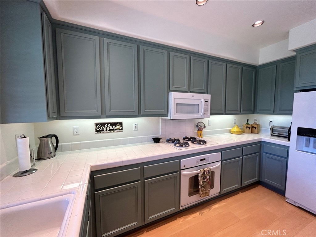 2811 Caponi Place Tustin, CA 92782 - Photo 7 of 50 a kitchen with a sink and a stove top oven
