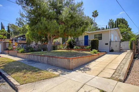 a view of a backyard with a large tree